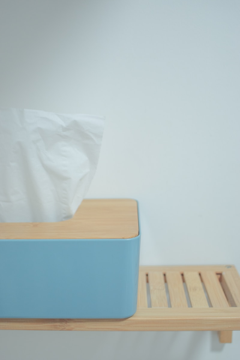 white tissue paper on blue plastic trash bin